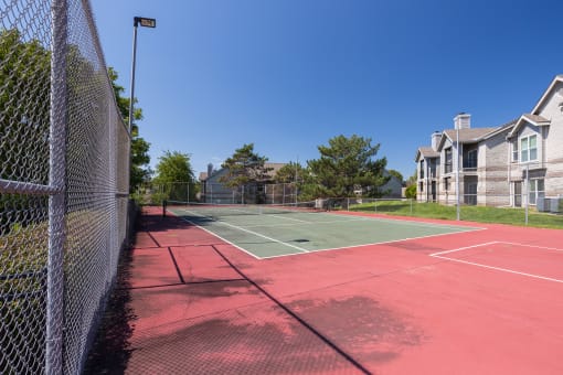 A tennis court at Hawthorne Apartment Homes, perfect for a match or practice session.
